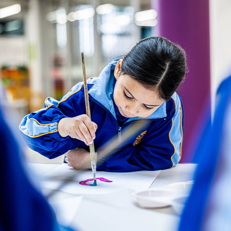 Student painting in the classroom at Our Lady Queen of Peace Primary School Greystanes
