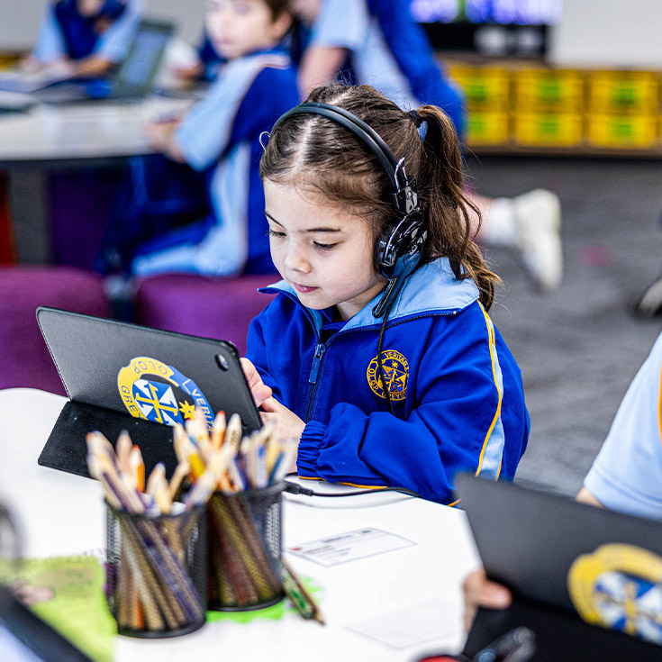 Student using her tablet in the classroom at Our Lady Queen of Peace Primary School Greystanes