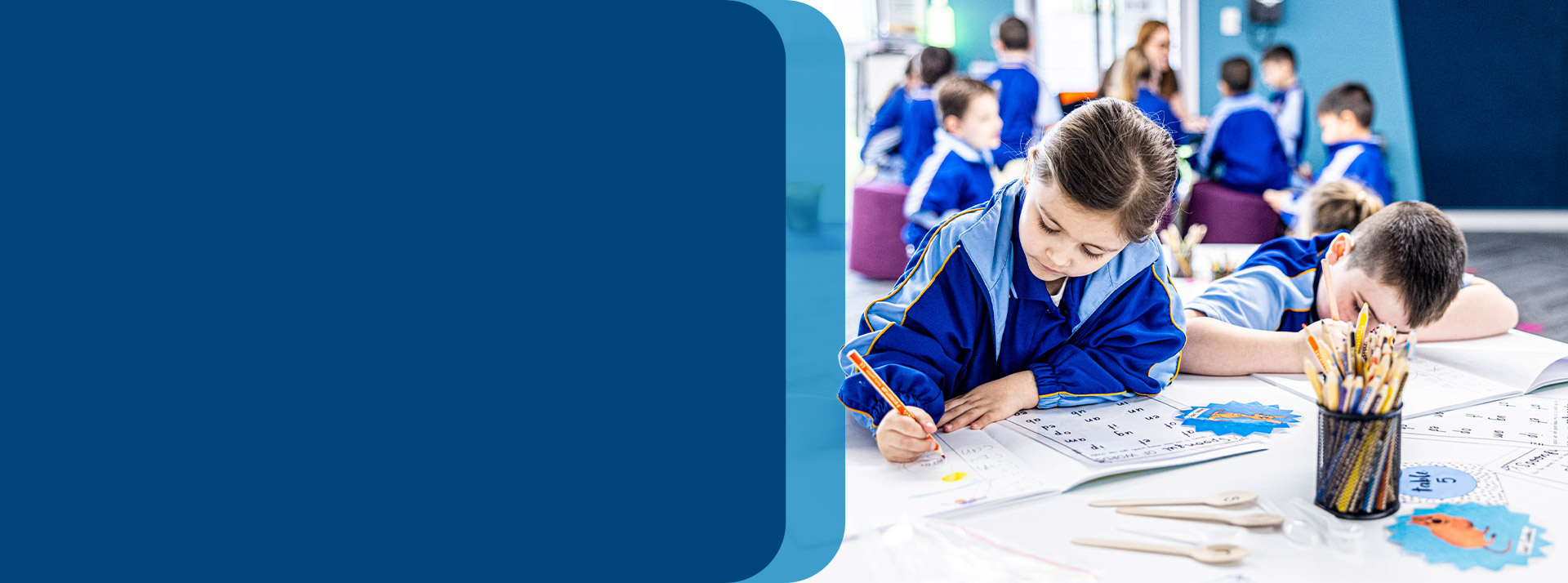 Students writing together in the classroom at Our Lady Queen of Peace Primary School Greystanes
