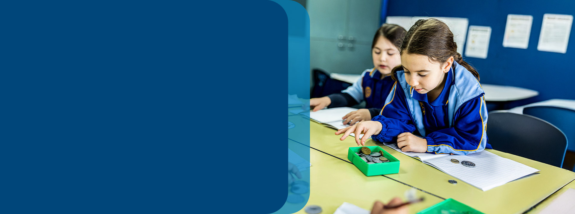 Student counting play money in the classroom at Our Lady Queen of Peace Primary School Greystanes