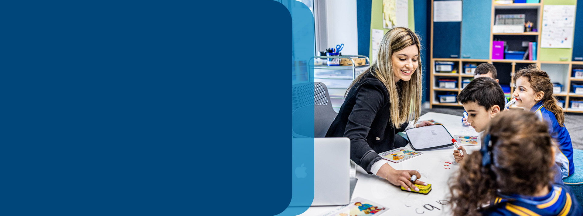 Teacher reading with her students in the classroom at Our Lady Queen of Peace Primary School Greystanes