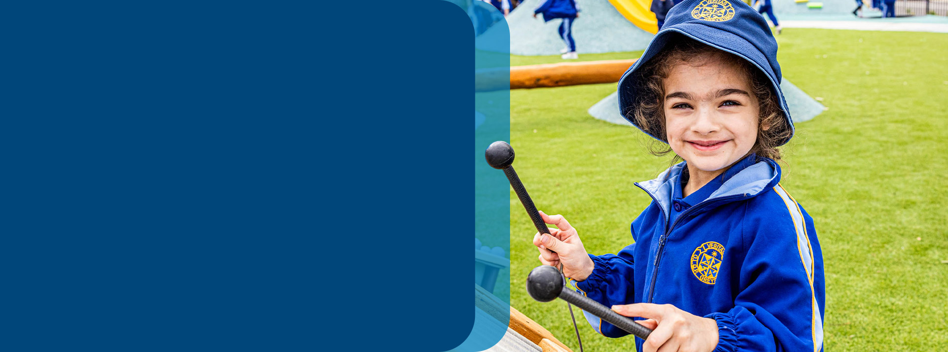 Student playing a drum in the playground at Our Lady Queen of Peace Primary School Greystanes