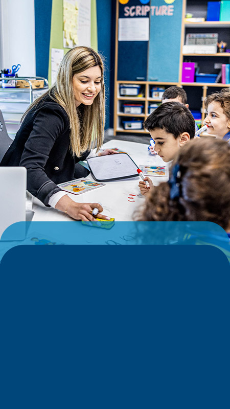 Teacher reading with her students in the classroom at Our Lady Queen of Peace Primary School Greystanes