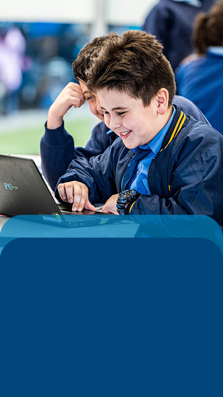 Student using his laptop in the classroom at Our Lady Queen of Peace Primary School Greystanes