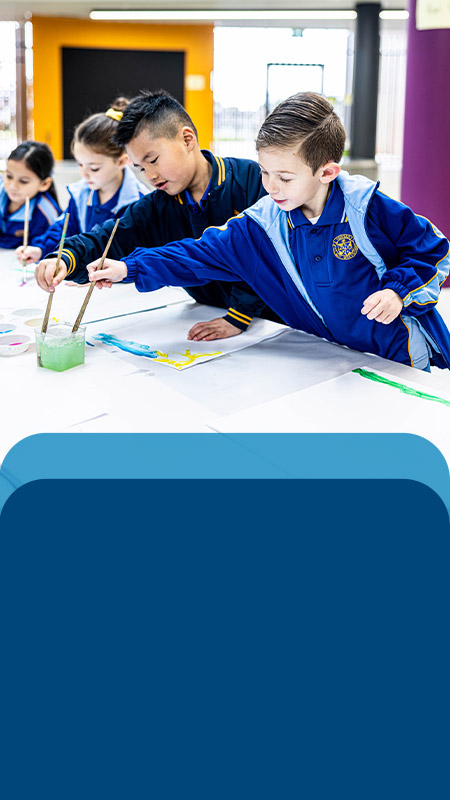 Students painting in the classroom at Our Lady Queen of Peace Primary School Greystanes