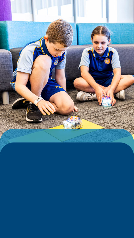 Students programming robots in the classroom at Our Lady Queen of Peace Primary School Greystanes