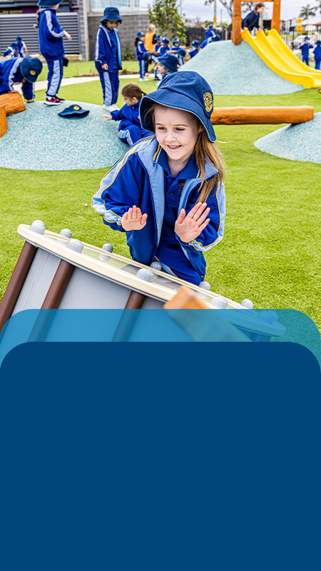 Student playing a drum in the playground at Our Lady Queen of Peace Primary School Greystanes