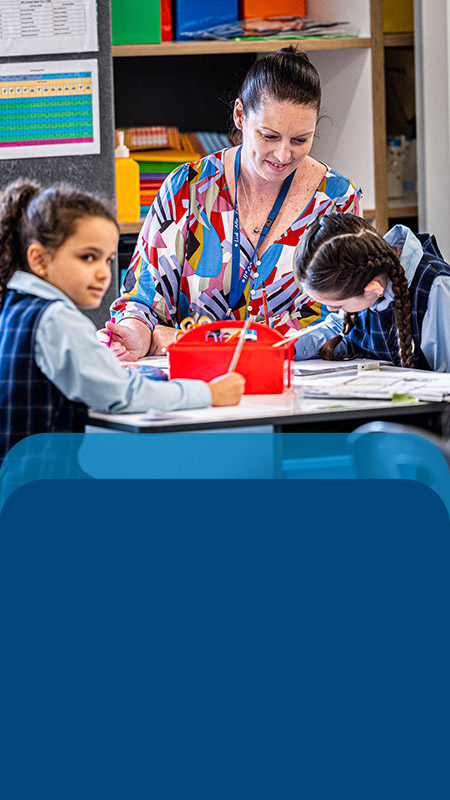 Teacher reading with her students in the classroom at Our Lady Queen of Peace Primary School Greystanes