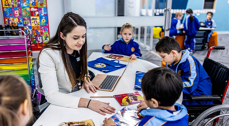 Teacher reading with her students in the classroom at Our Lady Queen of Peace Primary School Greystanes