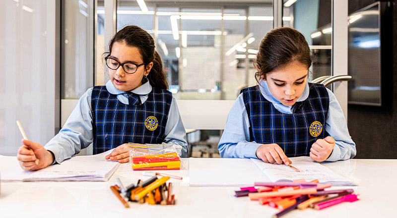 Students writing in the classroom at Our Lady Queen of Peace Primary School Greystanes
