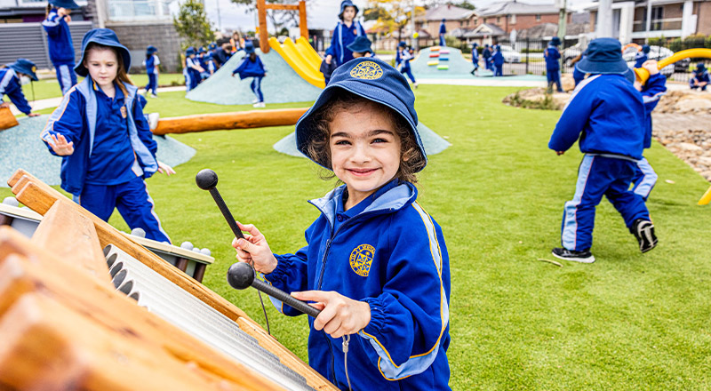 Student playing the xylophone in the playground at Our Lady Queen of Peace Primary School Greystanes