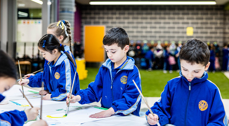 Students painting together in the purpose built learning facility