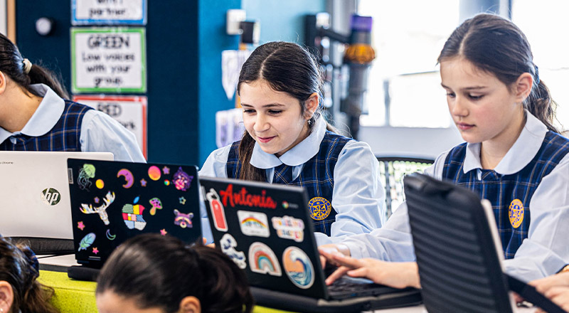 Students working on their laptops in the classroom at Our Lady Queen of Peace Primary School Greystanes