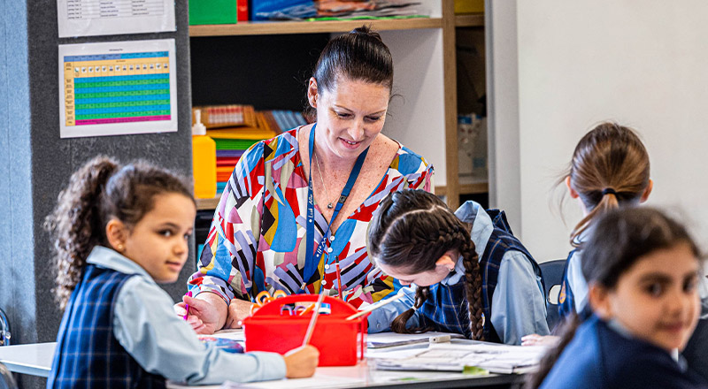 Teacher with her students in the classroom at Our Lady Queen of Peace Primary School Greystanes
