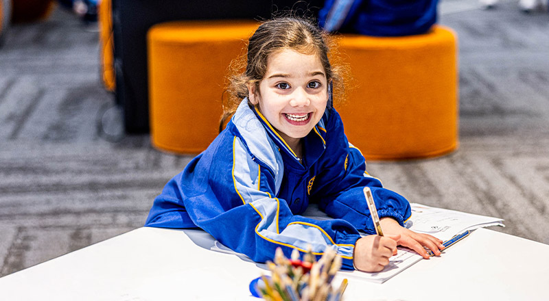 Student writing in the classroom at Our Lady Queen of Peace Primary School Greystanes