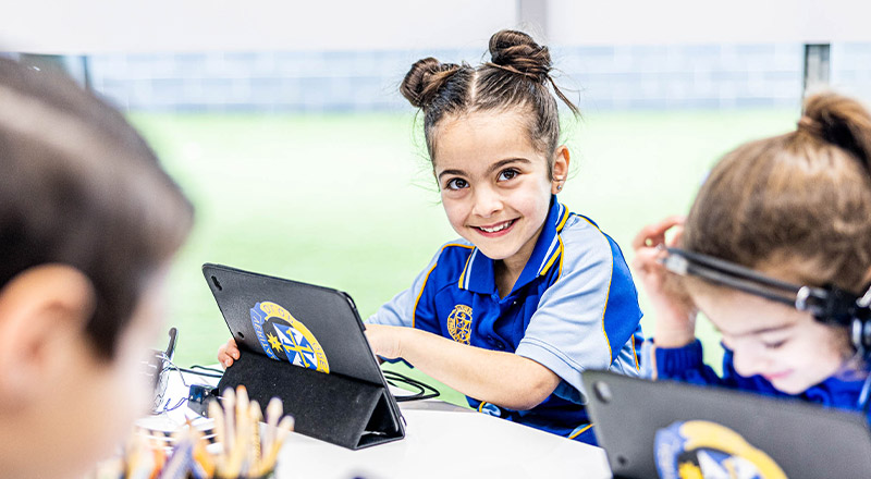 Student smiling in the classroom at Our Lady Queen of Peace Primary School Greystanes