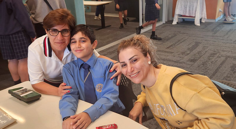 Student with his mum and grandmother in the classroom at Our Lady Queen of Peace Primary School Greystanes