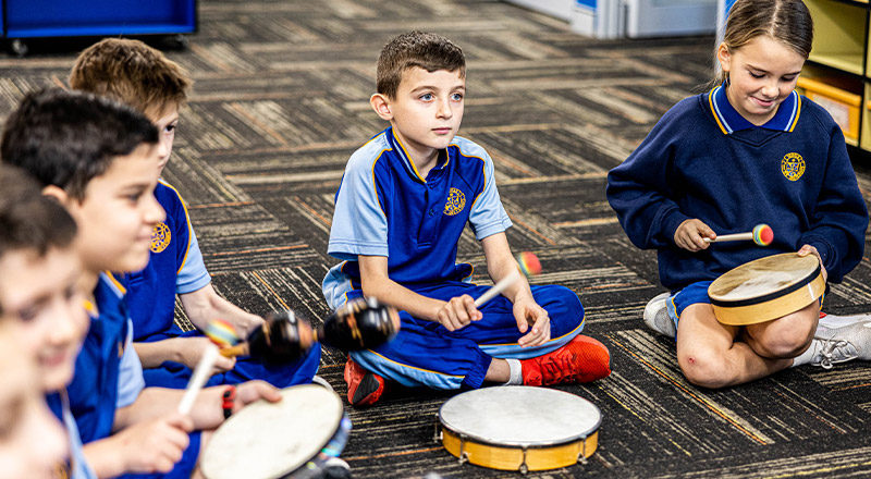 Students playing instruments in the classroom at Our Lady Queen of Peace Primary School Greystanes