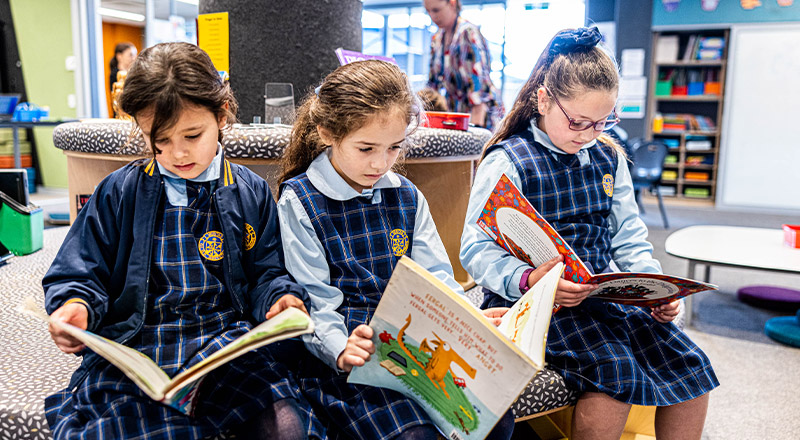 Students reading together in the library at Our Lady Queen of Peace Primary School Greystanes