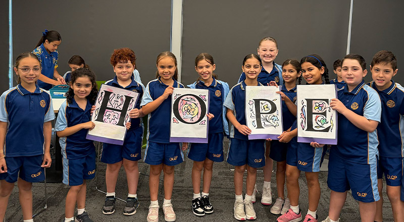 Students holding up the letters for HOPE in religion class at Our Lady Queen of Peace Primary School Greystanes