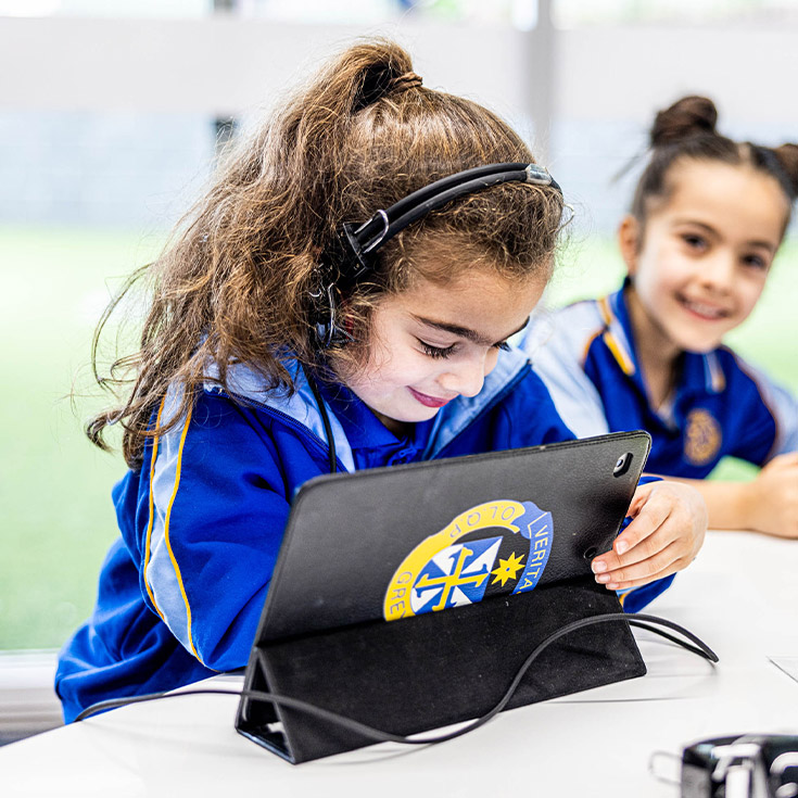 Student using her tablet in the classroom at Our Lady Queen of Peace Primary School Greystanes
