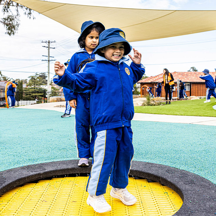 Student playing on the trampoline in the playground at Our Lady Queen of Peace Primary School Greystanes