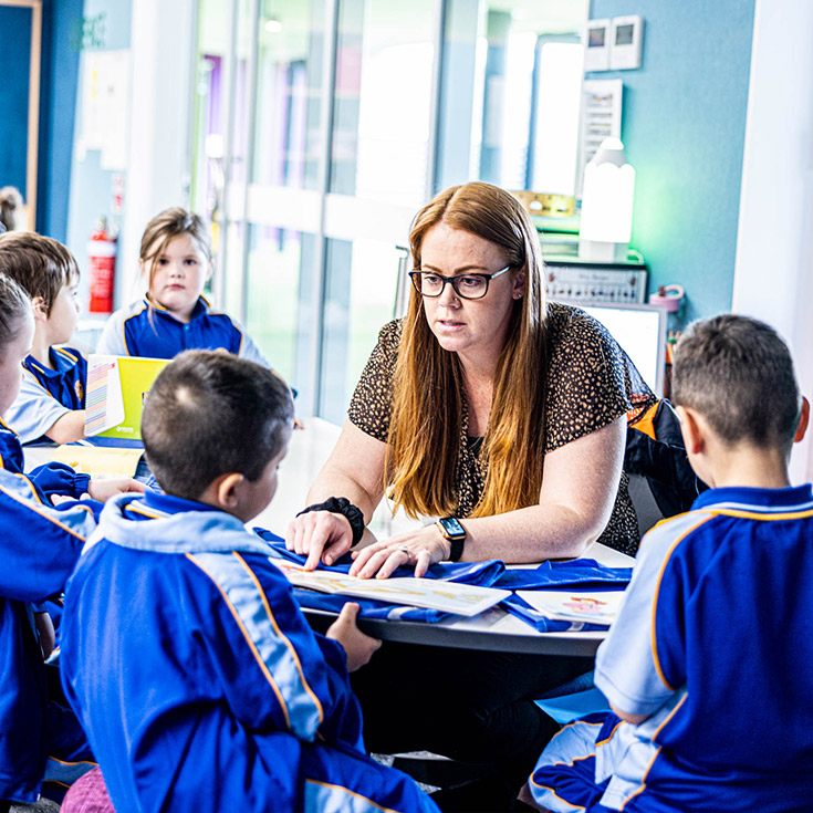 Teacher reading with her students in the classroom at Our Lady Queen of Peace Primary School Greystanes