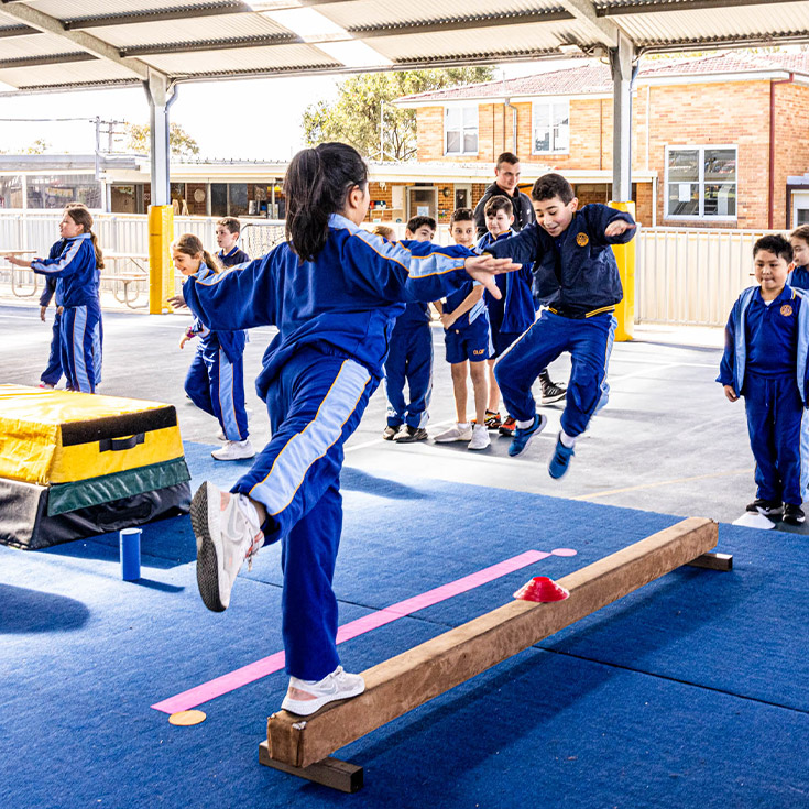 Students balancing in the playground at Our Lady Queen of Peace Primary School Greystanes