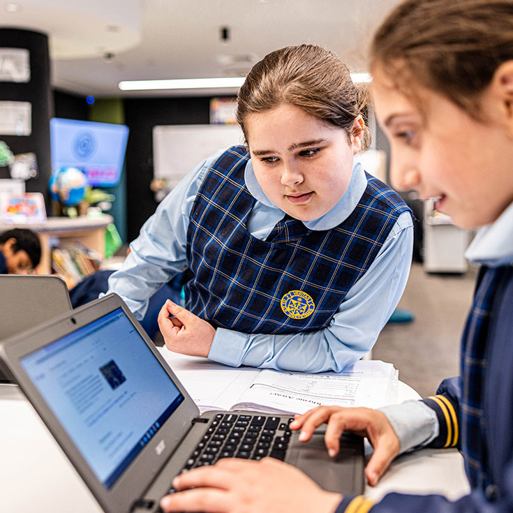 Students working on their laptops in the classroom at Our Lady Queen of Peace Primary School Greystanes